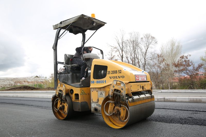 Road roller compacting fresh asphalt on a highway